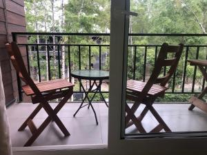 a table and two chairs on a porch with a table at Depto en condo Pucon Andino in Pucón