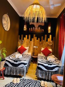 a room with two beds and a chandelier at Savannah House in Arusha