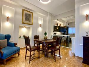 a kitchen and dining room with a table and chairs at Athenian Condo in Athens