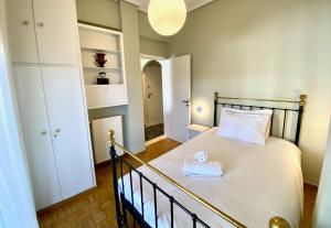 a bedroom with a bed in a room with a closet at Athenian Condo in Athens