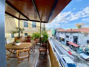 a balcony with a table and a view of a city at Athenian Condo in Athens