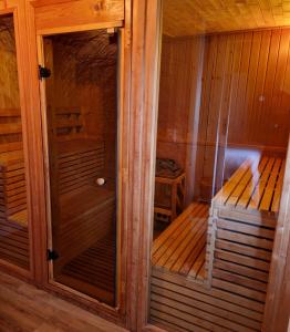 a sauna with two wooden benches in a room at B&B The Wellness Cottage in Dordrecht +17 photos
