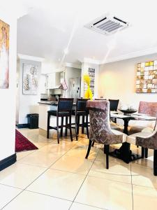 a kitchen and dining room with a table and chairs at The Sails Penthouse with Private Rooftop Pool in Durban