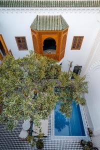 an overhead view of a building with an orange tree at Riad Botanica in Marrakesh