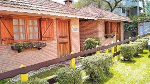 a model of a house with a toy train in the yard at Chales Encanto Suíço in Monte Verde