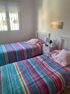 two beds sitting next to each other in a bedroom at Mirador de Turre in Turre