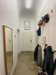 a room with a mirror and a hallway with a door at Industrial style loft in the heart of wiesbaden in Wiesbaden +1 photo