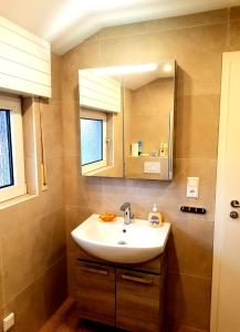 a bathroom with a sink and a mirror at City - Appartement in Lengerich