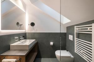 a bathroom with a sink and a toilet at Alpenrose Alpine Living in Selva