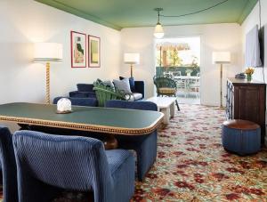 a living room with a pool table and chairs at Palihouse West Hollywood in Los Angeles