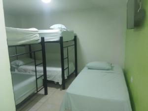 Cette chambre comprend deux lits superposés et un lit. dans l'établissement HOTEL BOSQUE DE LAS AMERICAS, à Carthagène des Indes