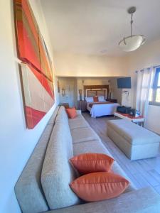 a living room with a couch and two pillows at Los Vientos Hotel in Bahía de los Ángeles