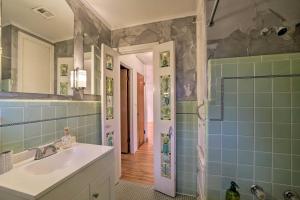 a bathroom with a sink and a shower with blue tiles at Tulsa Rental Home - Walk to Philbrook Museum in Tulsa