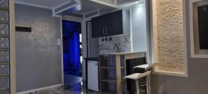 a kitchen with a counter and two chairs in a room at Top luxury apartment in Belgrade