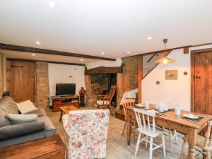 a living room with a couch and a table at Foxden in Sherborne