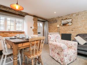 a living room with a table and a couch at Foxden in Sherborne