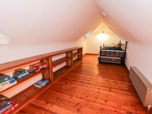 Dormitorio tipo loft con cama y suelo de madera en 1 Little Ripple Cottages, en Canterbury
