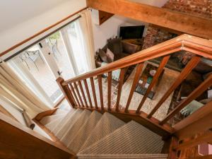 an overhead view of a wooden staircase in a living room at 1 Little Ripple Cottages in Canterbury