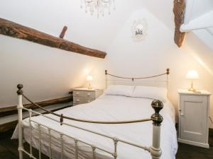 a bedroom with a bed and two night stands at Foxden in Sherborne