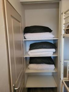 a closet with four pillows on shelves and a door at APPARTEMENT VALMEINIER 1800 / RESIDENCE L'OURS BLANC in Valmeinier