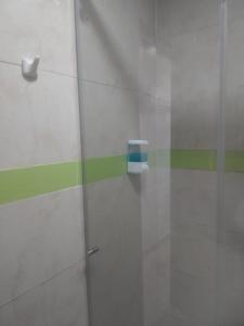 a glass door with a soap dispenser on a wall at HOTEL BOSQUE DE LAS AMERICAS in Cartagena de Indias