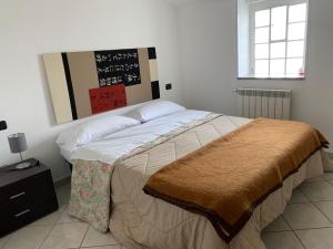 una camera da letto con un grande letto con una coperta marrone di B&B San Pietro Book sharing a Nola