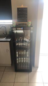 a refrigerator full of food in a kitchen at Exclusive townhouse Newton Park in Newton Park +15 photos