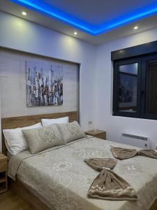 a bedroom with a large bed with a blue ceiling at Vila Pekovic Blue - Apartman TORG in Zlatibor