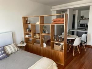 a bedroom with a bed and a dining room at Moderno departamento Palermo vista La Rural in Buenos Aires