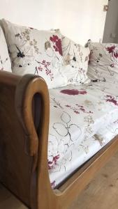 łóżko z kwiatową pościelą i poduszkami w obiekcie Appartement lumineux au coeur de Dieppe w mieście Dieppe