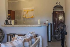 una camera con tavolo, mensola e divano di Little Heaven's Home, 1 bedroom cozy home a Malindi