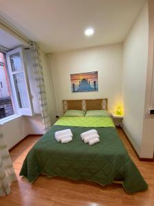 ナポリにあるAngy's Houseのベッドルーム1室(緑色のベッド1台、タオル2枚付)