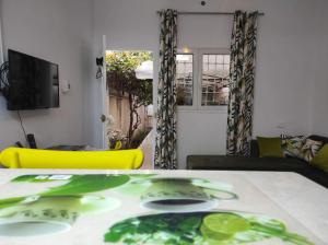 ein Wohnzimmer mit einem Tisch und einem gelben Stuhl in der Unterkunft Studio, quartier calme 10 min de l'aéroport Tunis Carthage , cité la Gazelle, près du Technopark in Jafar