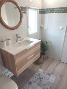 a bathroom with a sink and a mirror and a toilet at La Marisa, studio cosy 10min Disney. in Crecy la Chapelle