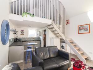 a living room with a couch and a stair case at Mountain View in Kinvara