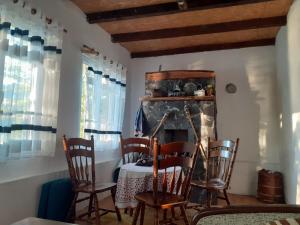 a room with a table and chairs and a fireplace at Vikend kuća Zlatarski DAR in Nova Varoš +28 photos