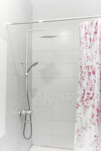 a shower in a bathroom with a shower curtain at Beautiful home with private rooms in Pantang
