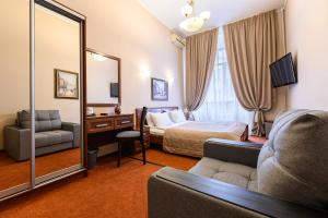 a hotel room with a bed and a mirror at Solo Prima in Saint Petersburg