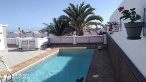 a swimming pool on the roof of a house at loft patri Caleta de Fuste in Caleta De Fuste