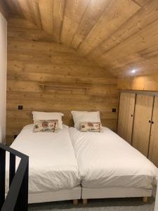 a bedroom with two beds in a room with wooden walls at Arcs 1950 , CALM Comme A La Montagne in Arc 1950 +33 photos