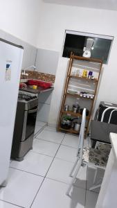 a kitchen with an open refrigerator and a stove at Apartamento em Pipa in Pipa