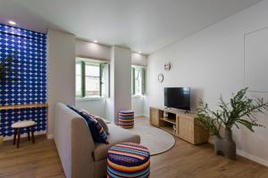 sala de estar con sofá y TV en Boutique Rentals- SEA Breeze Apt en Oporto