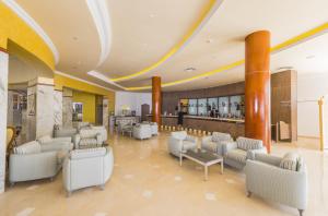 a lobby with couches and chairs and a bar at Abou Sofiane Hotel in Port El Kantaoui
