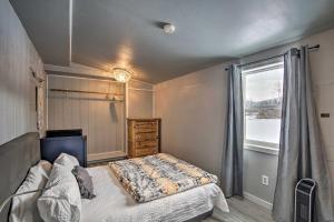 a bedroom with a bed and a window at Cozy Cle Elum Cabin with 3 Acres and Stocked Pond in Cle Elum