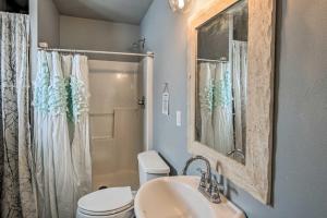 a bathroom with a toilet and a sink and a shower at Cozy Cle Elum Cabin with 3 Acres and Stocked Pond in Cle Elum +21 photos