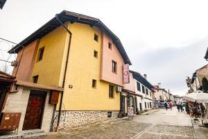 a yellow building on the side of a street at Lalev Guest House in Bansko