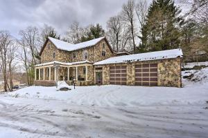 a house is covered in snow with a driveway at 1 Mi to Lake Wallenpaupack Spacious Poconos Villa in Hawley