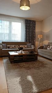 a living room with a couch and a coffee table at City Park Apartments in Pristina