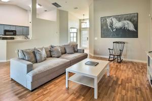 een woonkamer met een bank en een tafel bij Spacious Ocala Home with Lanai and Private Pool! in Ocala Ridge