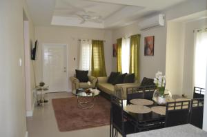 a living room with a couch and a table at Jamaica Tranquility in Lucea